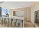 Modern kitchen with light wood cabinets, marble countertops, and breakfast bar at 1000 Water St # 1702, Tampa, FL 33602