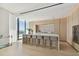 Modern kitchen with marble island, light wood cabinets, and city views at 1000 Water St # 1702, Tampa, FL 33602