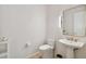 Modern bathroom with pedestal sink, gold fixtures, and a contemporary toilet at 1000 Water St # 1702, Tampa, FL 33602