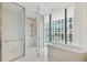 Modern bathroom with a walk-in shower, freestanding tub, and marble flooring at 1000 Water St # 1702, Tampa, FL 33602