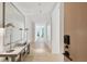 Bright hallway with light wood floors and a modern console table at 1000 Water St # 1702, Tampa, FL 33602