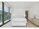 Spacious primary bedroom with a plush bed and access to a balcony at 1000 Water St # 1702, Tampa, FL 33602