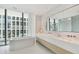 Spa-like bathroom with a freestanding tub, double sinks, and marble finishes at 1000 Water St # 1702, Tampa, FL 33602