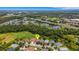 Aerial shot of houses surrounded by green space, trees, highways and distant city at 27542 Sky Lake Circle, Wesley Chapel, FL 33544