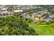 Stunning aerial view of a home with a private pool surrounded by lush greenery and neighborhood amenities at 27542 Sky Lake Circle, Wesley Chapel, FL 33544