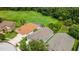 An aerial view shows the home's location with green space, well-maintained lawns, and other houses in the community at 27542 Sky Lake Circle, Wesley Chapel, FL 33544