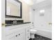 Modern bathroom features black and white tile floors, white vanity and a bathtub with a shower at 27542 Sky Lake Circle, Wesley Chapel, FL 33544