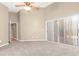 Bright bedroom with plush carpeting, neutral walls, and sliding glass door access to outdoor patio at 27542 Sky Lake Circle, Wesley Chapel, FL 33544