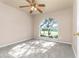 Cozy bedroom with plush carpet, neutral color walls, ceiling fan, and plenty of natural light at 27542 Sky Lake Circle, Wesley Chapel, FL 33544