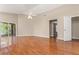 Primary bedroom with hardwood floors, ceiling fan, and sliding glass doors at 27542 Sky Lake Circle, Wesley Chapel, FL 33544