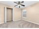 Neutral bedroom showcases closet with double doors, plush carpet and a window view to the outside at 27542 Sky Lake Circle, Wesley Chapel, FL 33544