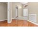 The foyer features wood floors transitioning to tile, with views to the front door and closet at 27542 Sky Lake Circle, Wesley Chapel, FL 33544