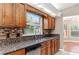 Kitchen features stainless steel appliances, granite countertops, mosaic backsplash, and wood cabinets at 27542 Sky Lake Circle, Wesley Chapel, FL 33544