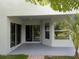 Covered patio with light grey paint job, sliding glass doors, and view of the backyard at 27542 Sky Lake Circle, Wesley Chapel, FL 33544