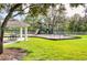 Community playground featuring slides, climbing equipment, swings, and covered picnic area at 27542 Sky Lake Circle, Wesley Chapel, FL 33544