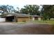 Ranch style home with attached garage and carport, situated on a spacious lot with mature trees at 3706 Joe Sanchez Rd, Plant City, FL 33565