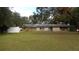 Ranch-style home with a spacious lawn and white fence at 3706 Joe Sanchez Rd, Plant City, FL 33565