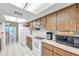 Efficient kitchen with wood cabinets, white appliances, and good counter space at 3840 Staysail Ln # 3840, Holiday, FL 34691