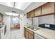 Kitchen features wood cabinets, double sink, and view to dining area at 3840 Staysail Ln # 3840, Holiday, FL 34691