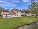 Aerial view of condo building with private patio overlooking lake at 3840 Staysail Ln # 3840, Holiday, FL 34691