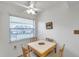 Simple dining area with four chairs and a small table set in front of a window at 3840 Staysail Ln # 3840, Holiday, FL 34691