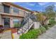 Two-story condo building with stairs and landscaping at 3840 Staysail Ln # 3840, Holiday, FL 34691