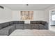 Relaxing living room featuring a sectional sofa and large piece of wall art at 3840 Staysail Ln # 3840, Holiday, FL 34691