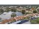 Aerial view of waterfront community with lake, lush landscaping, and convenient parking at 3840 Staysail Ln # 3840, Holiday, FL 34691
