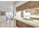 Kitchen with wood cabinets, double sink, and breakfast bar at 3840 Staysail Ln # 3840, Holiday, FL 34691