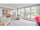 Bright sunroom with lake view, comfy chairs, and access to bedroom and living areas at 3840 Staysail Ln # 3840, Holiday, FL 34691