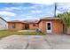 Spacious backyard featuring an orange house with solar panels and a concrete patio at 460 48Th S St, St Petersburg, FL 33711