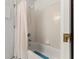 A well-lit bathtub with a shower features a shower curtain and tiled walls, showcasing the bathroom's cleanliness at 460 48Th S St, St Petersburg, FL 33711