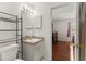 Cozy bathroom featuring a white vanity, open shelving, and a doorway leading into an adjacent bedroom at 460 48Th S St, St Petersburg, FL 33711