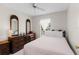 Bright bedroom with traditional furniture, featuring a decorative mirror and a view to the outdoors at 460 48Th S St, St Petersburg, FL 33711