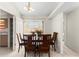 Cozy dining room with wood table, chairs, tile flooring and modern light fixture at 460 48Th S St, St Petersburg, FL 33711