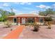 Charming single-story home with updated landscaping and a brick paved driveway on a sunny day at 460 48Th S St, St Petersburg, FL 33711