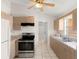Functional kitchen featuring tile floors, neutral cabinets and white appliances at 460 48Th S St, St Petersburg, FL 33711