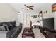 Inviting living room with a comfortable sofa, ceiling fan, tile floors, and dining area, perfect for relaxing and entertaining at 460 48Th S St, St Petersburg, FL 33711