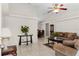 Bright living room with tile floors, neutral paint, ceiling fan, and view to dining area at 460 48Th S St, St Petersburg, FL 33711