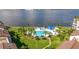 Community pool with lounge chairs, umbrellas, and waterfront access at 5281 Isla Key S Blvd # 206, St Petersburg, FL 33715