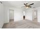 Large bedroom with carpeted floor, ceiling fan, and access to a closet and bathroom at 5315 Companion Ln, Tampa, FL 33619