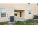 Private backyard patio with AC units and small lawn area at 5315 Companion Ln, Tampa, FL 33619
