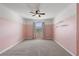Spacious bedroom with pink walls, ceiling fan, and large window at 5315 Companion Ln, Tampa, FL 33619