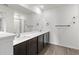 Double vanity bathroom with dark brown cabinets, a large mirror, and a shower at 5315 Companion Ln, Tampa, FL 33619