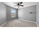 Simple bedroom with gray walls, ceiling fan, and window with blinds at 5315 Companion Ln, Tampa, FL 33619