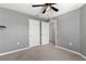 Empty bedroom with gray walls, ceiling fan, and doors to hallway at 5315 Companion Ln, Tampa, FL 33619