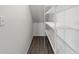 White shelving unit in a spacious storage room with wood-look flooring at 5315 Companion Ln, Tampa, FL 33619