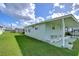 Light green single-wide mobile home with covered carport at 5330 Vera St, Zephyrhills, FL 33542