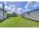 View of the backyard showing multiple sheds and green grass at 5330 Vera St, Zephyrhills, FL 33542