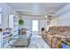 Cozy living room featuring a brown leather couch and a glass coffee table at 5330 Vera St, Zephyrhills, FL 33542